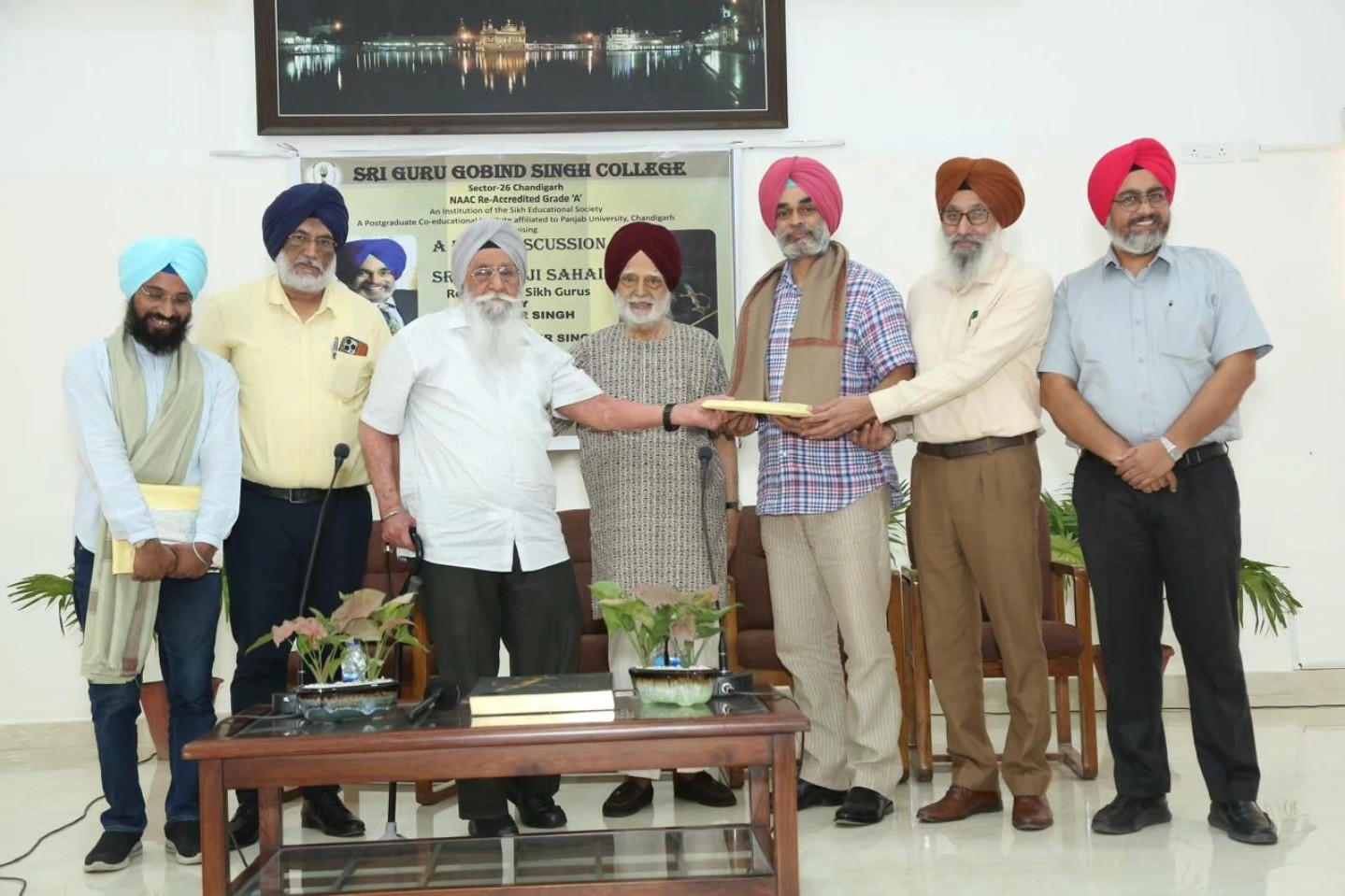 Author S. Gurbir Singh being felicitated during the session, joined by management members and the Principal, SGGS College.